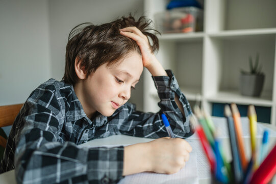 Schoolboy feeling fatigue and depression while studying at home