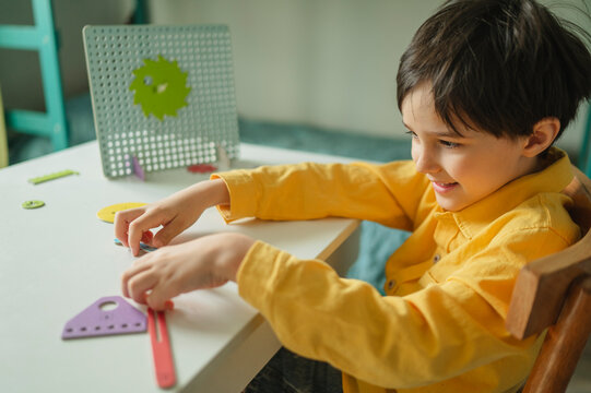 Student plays with constructor toy at home learning mechanics