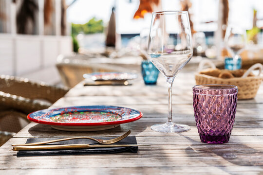 Empty glasses and plate on table at restaurant