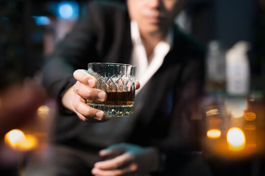 Closeup businessmen holding a glass of whiskey