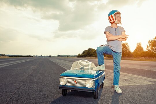 Boy with pedal car on race track