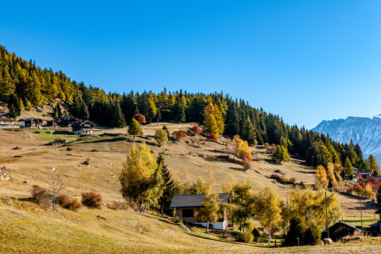 Autumn landscape with wooden chalets in Mund Switzerland