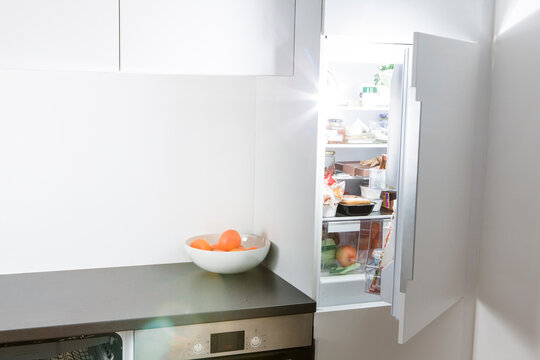 Modern kitchen, open fridge and light
