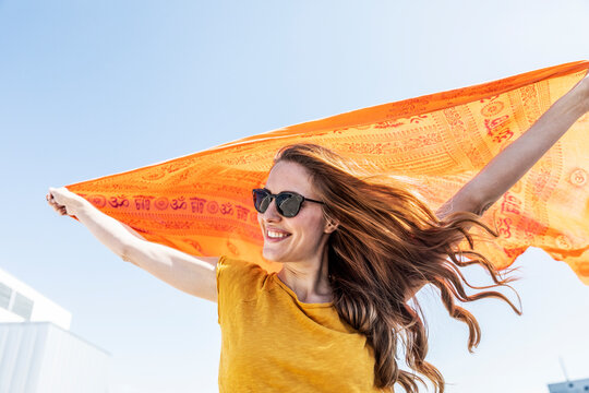 Portrait of smiling woman with sunglasses and cloth