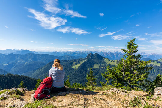 Germany, Bavaria, Female hiker admiring view of Rossstein and Buchstein peaks in Bavarian Prealps