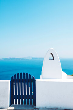 Greece, Santorini, Oia, gate and chimney in front of the sea