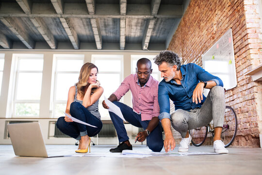 Team of architects discussing the rebuilding of a loft office