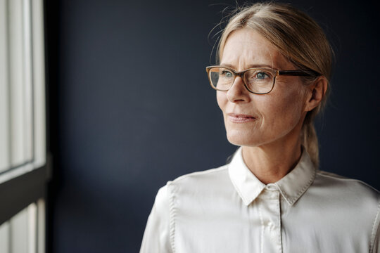 Businesswoman in office looking out of window