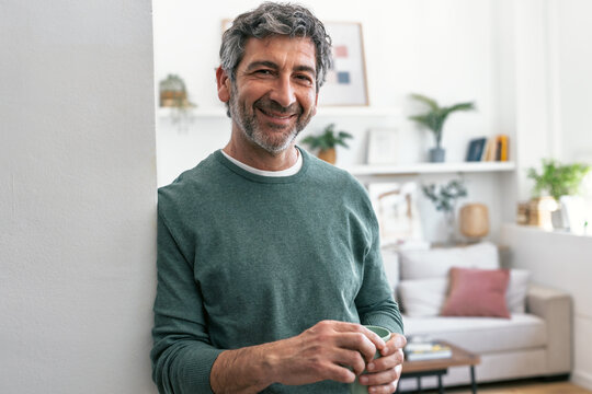 Smiling resident relaxing at home with a cup of coffee