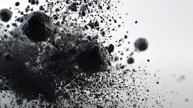 Close-up of dark, granular material exploding outwards against a white background.