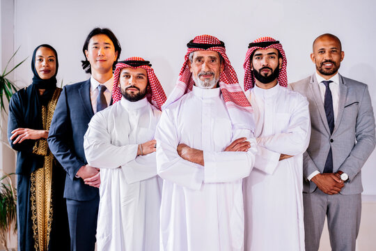 Confident international business team standing in Riyadh office