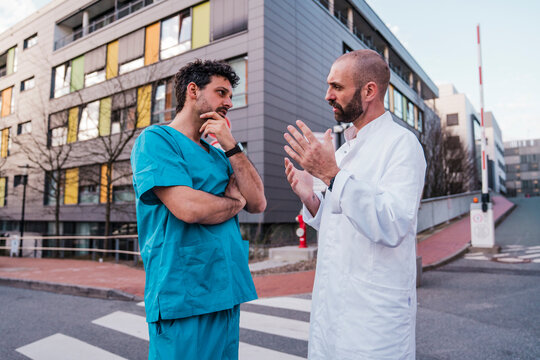 Doctor and surgeon in consultation outside a hospital building