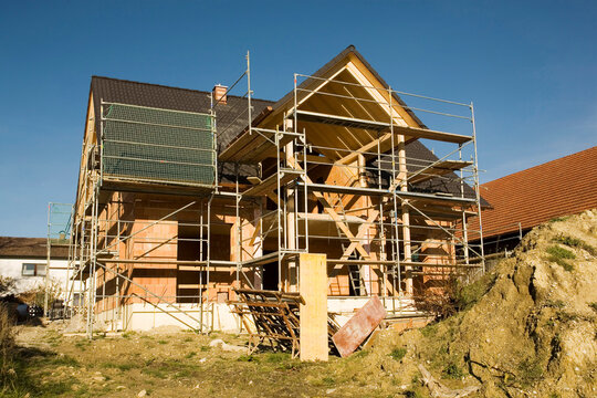 Residential house under construction with scaffolding outdoors
