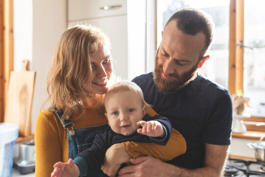 Happy affectionate family in the kitchen at home