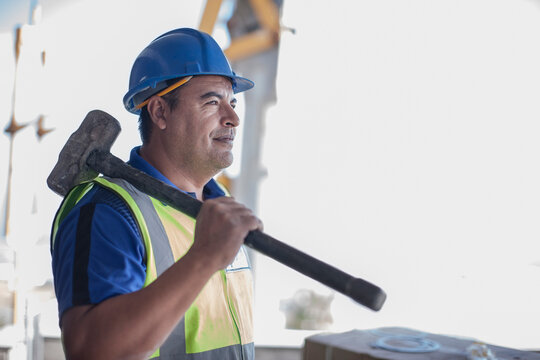 Confident construction worker with sledgehammer