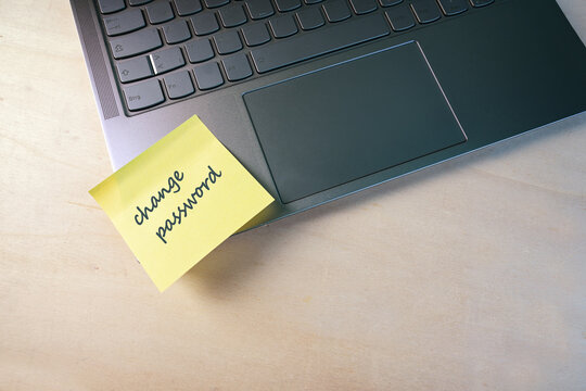 Sticky note with text change password on a laptop, protection of sensitive data from access by others, security concept, copy space