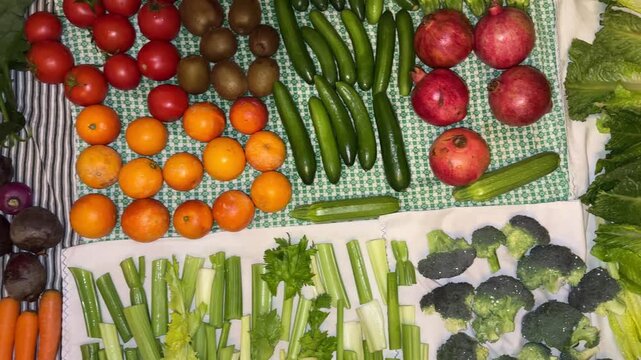 Birdseye overhead top view of colorful fruits vegetables fresh organic healthy nutrition include carrot Persian pomegranate orange kiwi beetroot celery lettuce cucumber tomato broccoli on carpet iran