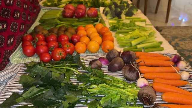 Fresh organic agriculture product and vegetables spinach tomato cucumber carrot beetroot lettuce celery colorful vibrant on Persian Iranian carpet pattern rustic flatlay overhead still life in kitchen