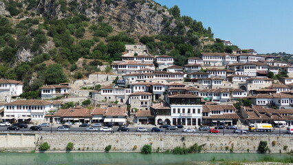 Obraz premium Cinematic aerial view of the iconic UNESCO stone town of Berat and the historic Gorica bridge over Osum river, Albania