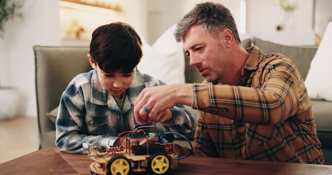 Dad, kid and building with toy car in home for assembling parts, bonding or fun activity together. Father, child or helping son on electrical motor vehicle for junior engineering or learning in house