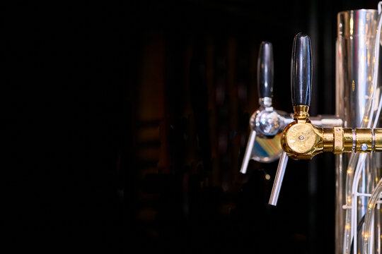 Beer drink faucets dispensers on black in bar
