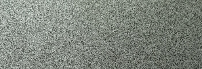 Fototapeta premium Terrazzo cement background with black and white stone grains scattered all over concrete floor