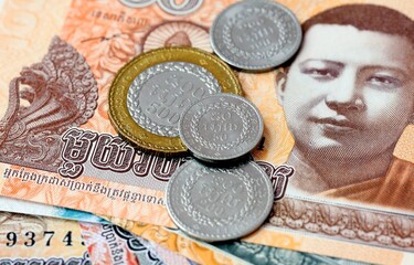 Cambodian riel money bills and coins on table. Cambodia cash of KHR currency © Larysa