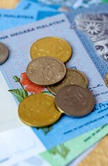 Malaysian ringgit money bills and coins on table. Malaysia cash of MYR currency close up © Larysa