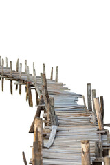 Fototapeta premium A long rickety and uneven handmade wooden bridge stretching out and isolated on a white background.