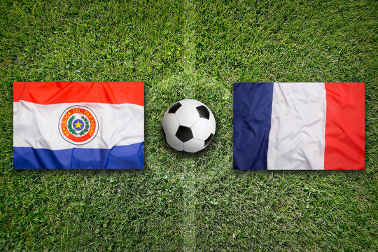 Paraguay vs. France flags on a soccer field