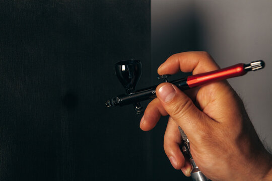 a man painting with an airbrush