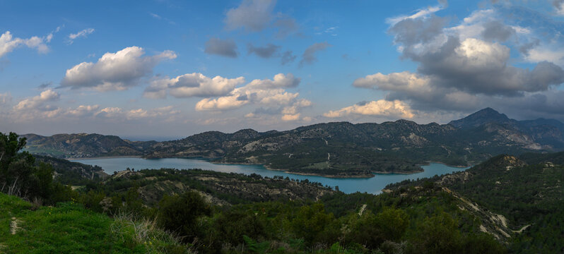 Serene lake view with rolling hills under a dreamy sky in early evening light