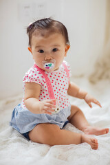 Fototapeta premium A cute 1-year-old Asian girl indoors