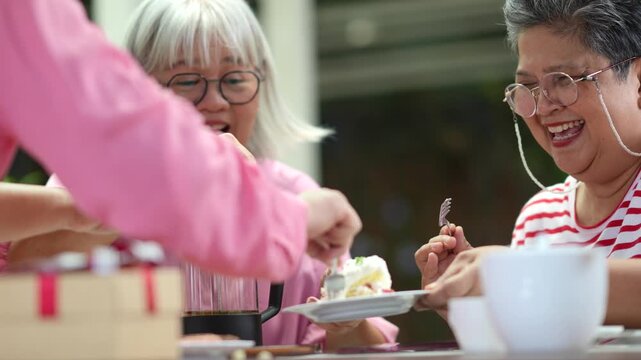 Happy senior friends enjoying meal together with genuine smiles and laughter, sharing meaningful conversations and celebrating friendship during active retirement lifestyle and social gathering