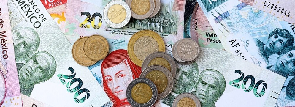 Mexican peso money banknotes and coins on table. Mexico cash bills of MXN currency