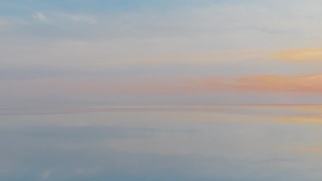 Soft pastel sunset reflection on calm sea horizon, aesthetic 3D background