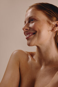 Redhead woman with glowing skin in skincare portrait