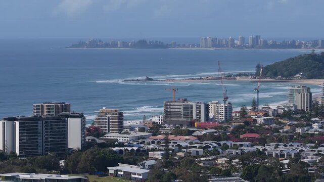 Slow reverse aerial view moving backward while tracking left over Palm Beach and Currumbin Alley on the Gold Coast, Queensland, Australia