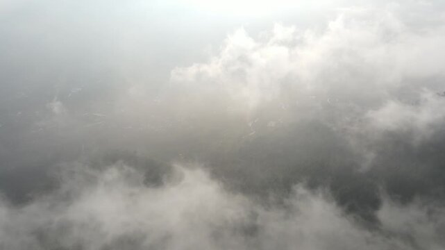 Cinematic opening footage. Mist shrouds Mount Andong, Central Java, Indonesia.