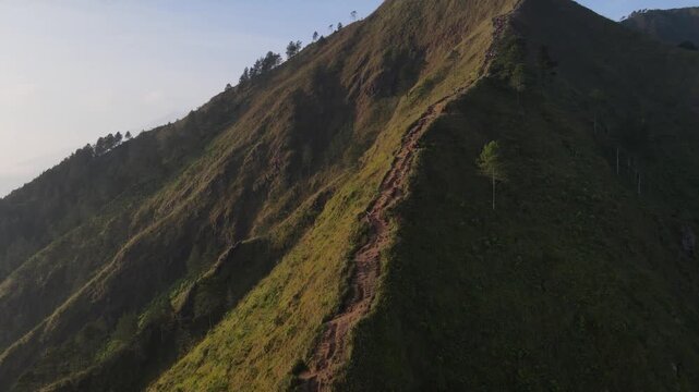 Aerial view of the Mount Andong climbing route via the Temu Kidul Basecamp. Drone footage of hiking trail in Central Java, Indonesia.