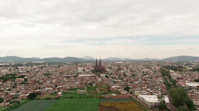 Aerial flyover Zamora de Hidalgo neighbourhoods, overlooking the Sacred Heart Expiatory Temple in the city center.