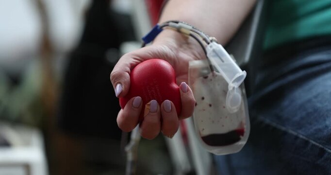 Blood donor hand detail during blood donation procedure