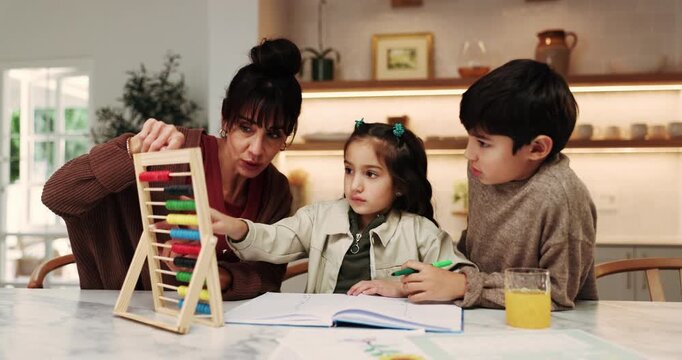Mother, kids and learning in home with abacus, homework discussion and practice math for development. Woman, talk and children in house with counting tool, school assessment and help for education.