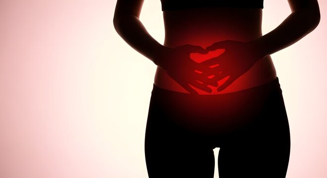 Woman's silhouette with hands forming heart over red glowing abdomen. Abdominal pain, menstrual cramps, or gut health concept.