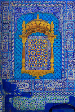View of the intricate blue and white kashi-kari tile work and yellow decorative arch at the Shrine of Sachal Sarmast in Daraza Sharif, Sindh, Pakistan.