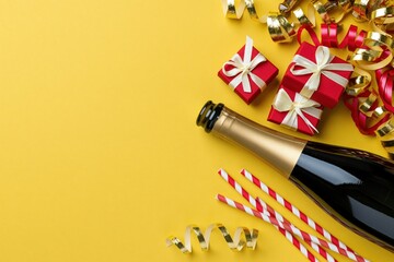 Fototapeta premium The Champagne Bottle centerpiece with Gift Boxes and Festive Ribbons