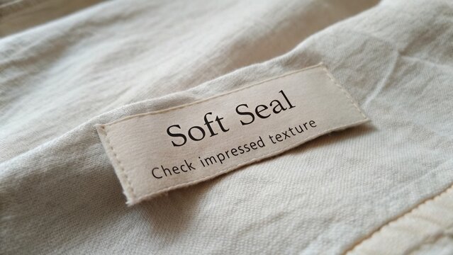 Soft Seal Fabric Tag with Impressed Texture on Soft Textured Textile for Fashion and Design Applications