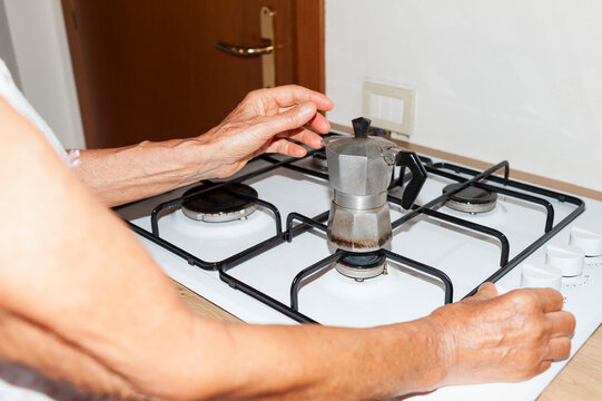 Placing Moka Pot on Gas Stove for Coffee Brewing