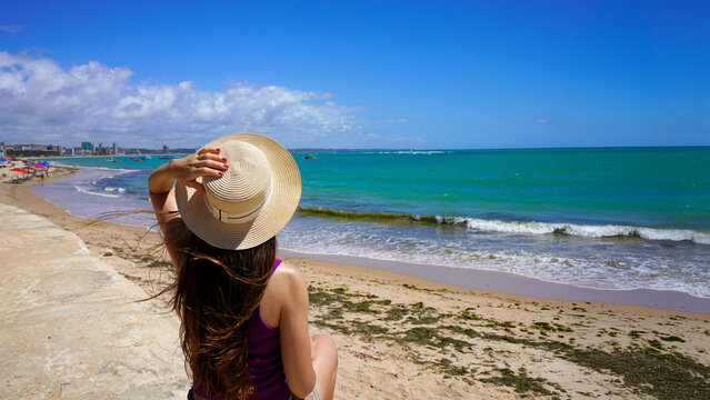 Woman enjoying view of Pajucara beach, Maceio, Brazil