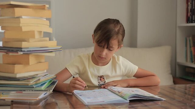 Elementary school student writing in workbook at home